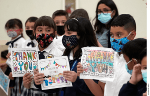 Children wait for Florida Governor Ron DeSantis to arrive at a bill signing ceremony at St. John the Apostle School, Tuesday, May 11, 2021, in Hialeah, Fla.