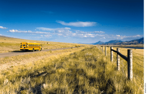 A bus drives down a rural road.