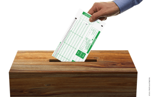 Illustration of a hand dropping a scantron sheet into a ballot box