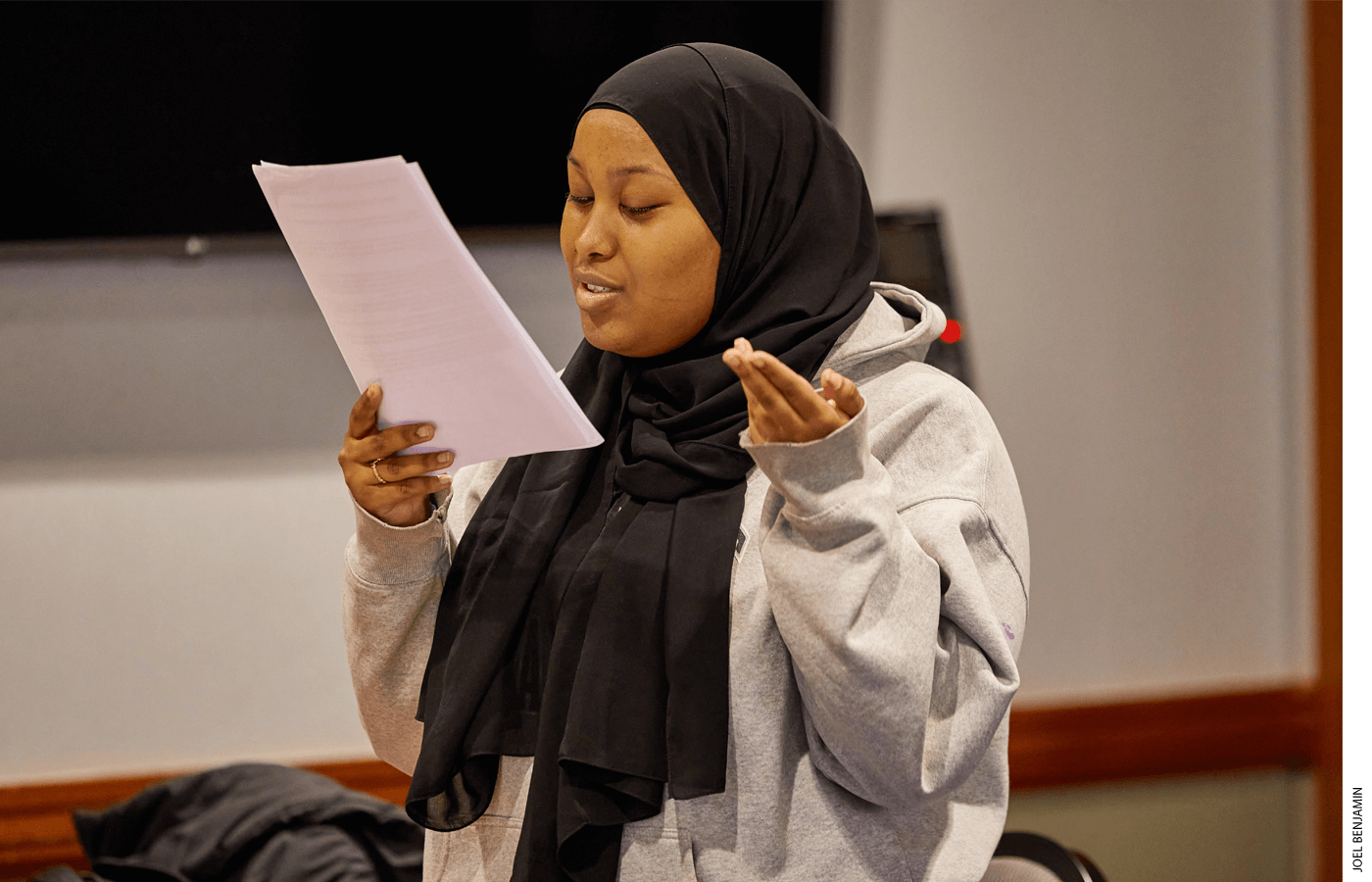 Aisha Mohamed, a novice-level debater with Josiah Quincy Upper School, delivers her opening speech at the tournament, reading from prepared evidence.