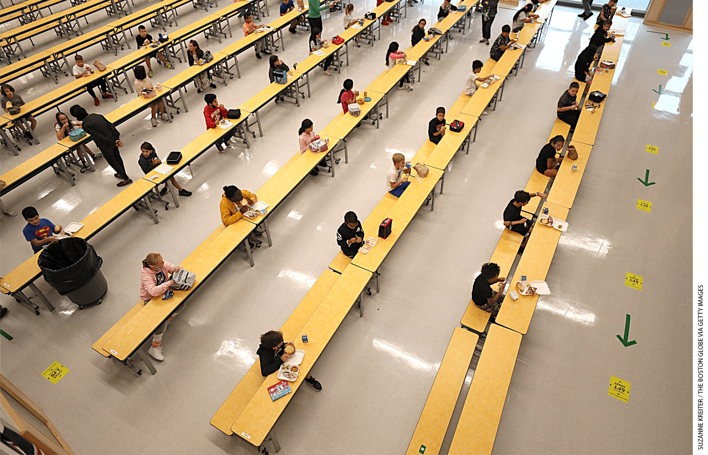 School children are spaced apart in one of the rooms used for lunch at Woodland Elementary School in Milford, Massachusetts.