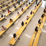 School children are spaced apart in one of the rooms used for lunch at Woodland Elementary School in Milford, Massachusetts.