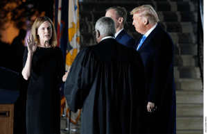 President Donald Trump watches as Supreme Court Justice Clarence Thomas administers the Constitutional Oath to Amy Coney Barrett on the South Lawn of the White House in Washington, Monday, Oct. 26, 2020, after Barrett was confirmed by the Senate earlier in the evening.