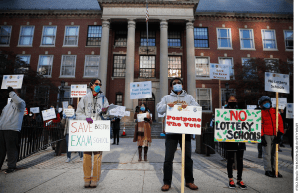 Protesters calling for Boston schools to keep the admissions exam in place for exam schools rally outside of Boston Latin School in Boston on October 18, 2020.