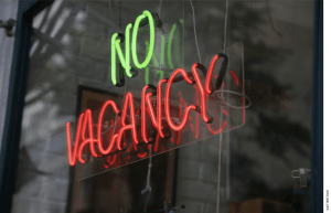 Neon sign in a window that reads "No Vacancy"