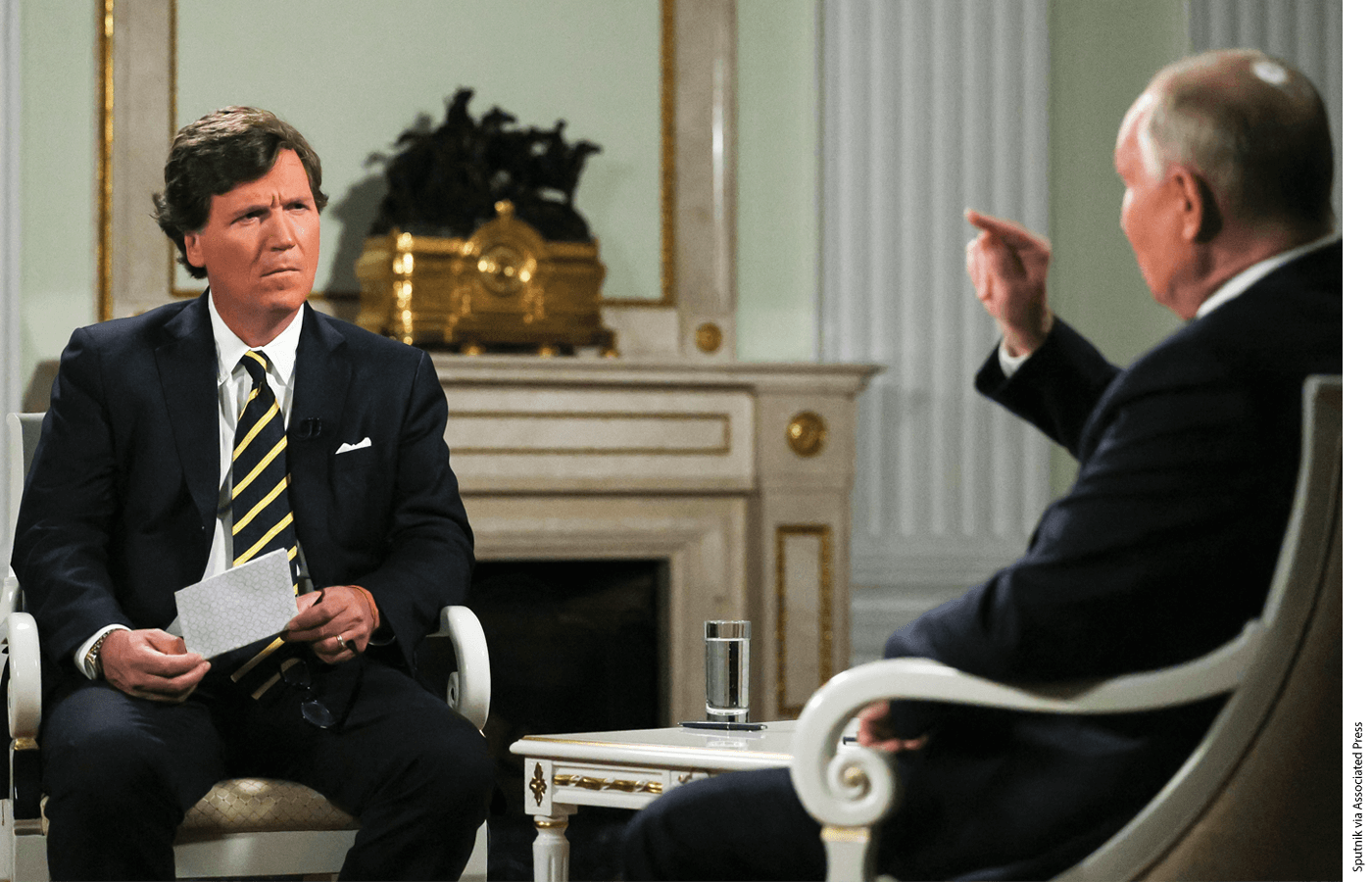 Russian President Vladimir Putin, right, gestures as he speaks during an interview with former Fox News host Tucker Carlson at the Kremlin in Moscow, Russia, Tuesday, Feb. 6, 2024.