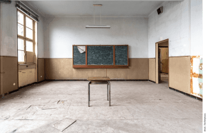 One desk in an empty classroom