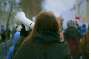 Photo of a young woman demonstrating at a protest