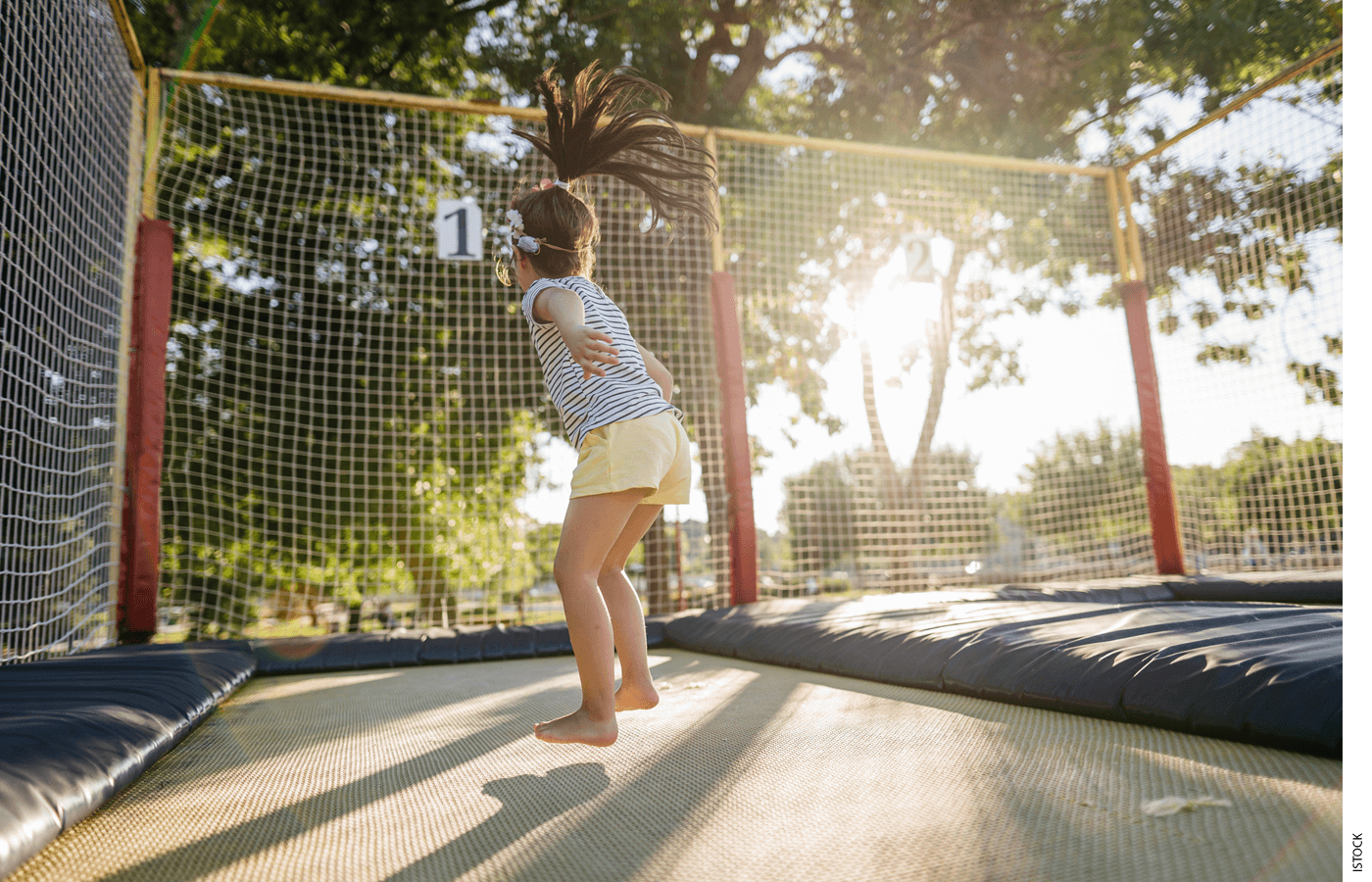 A child playing on a trampoline