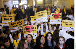 Private and home school students, their parents and advocates crowed part of the second floor of the Kansas Statehouse for a rally on education, Wednesday, Jan. 25, 2023, in Topeka, Kansas.