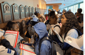 Students from the 6th grade at Nathan Hale School complete a "bingo challenge" as part of the Red Sox Hall of Fame stop on their guided tour of the Fenway Park Learning Lab.