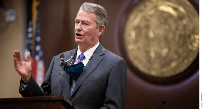 Idaho Governor Brad Little speaking at a podium